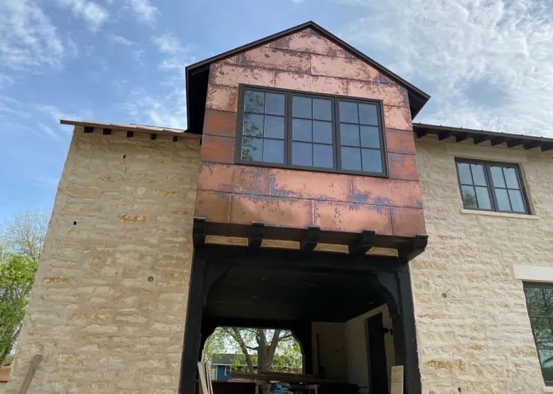 Copper metal panel facade on a stone building for Skylight Installation in Merrydale